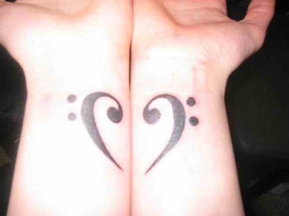 A beautiful heart tattoo divided on two hands great couple tattoo